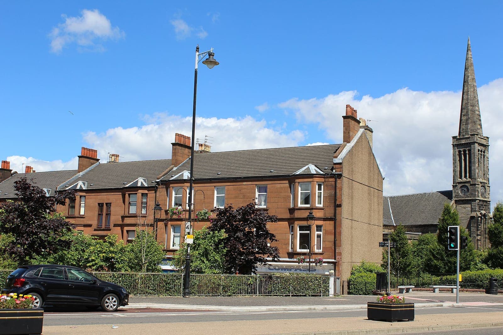 Sandstone tenements and shops on Main Street in Barrhead town centre