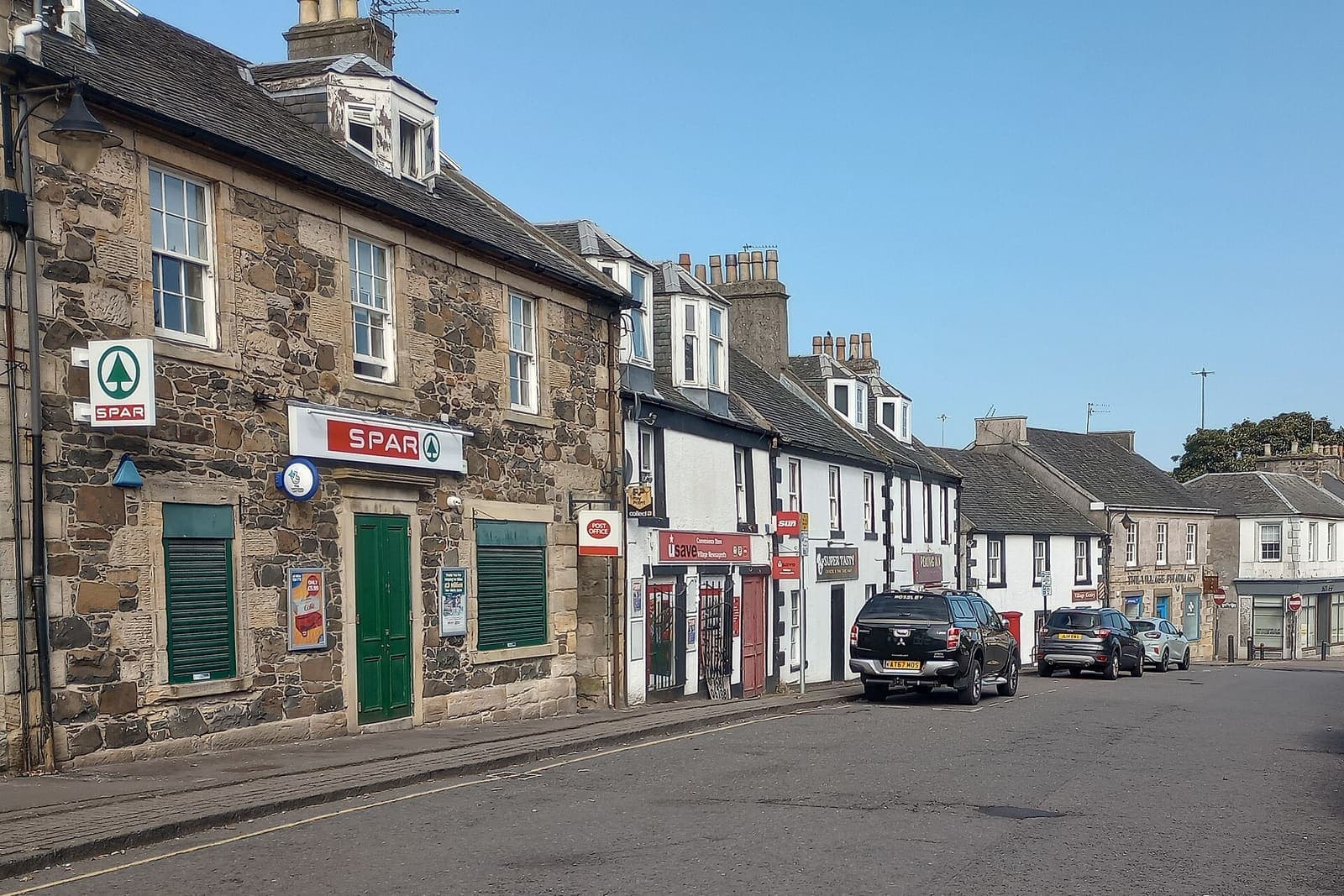 Footpaths and flat-roofed terraces in Seafar with Cumbernauld town centre behind